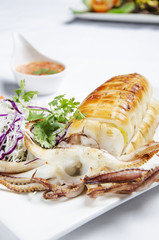 Delicious BBQ squid served with spicy sauce