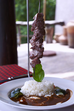 Grilled beef kebabs served basis with timbale of rice