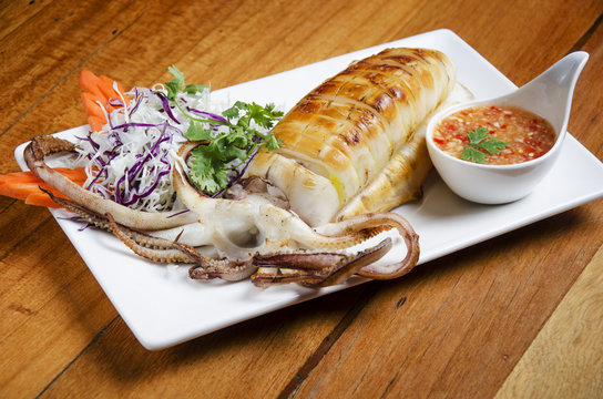 Delicious BBQ cuttle fish on white dish