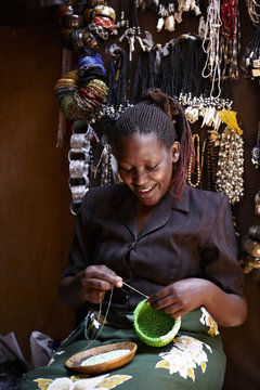 Smiling woman working in a street market in Nairobi (Kenya)