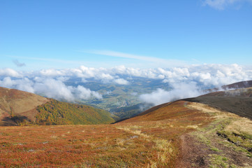 Fototapeta premium Mountains cloudscape panorama adove clouds