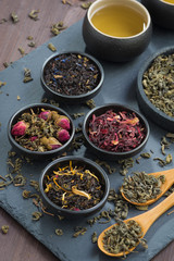 assortment of dry tea in bowls, top view