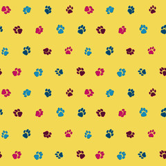 Funny seamless pattern with cats footprints on a yellow backgrou