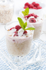 dessert with oatmeal, whipped cream and raspberries, close-up