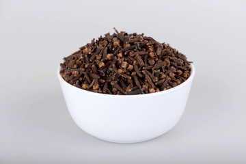 Cloves in white bowl with white background