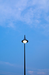 Street electric lamp on blue sky background