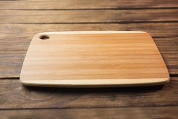 Chopping board on wooden table