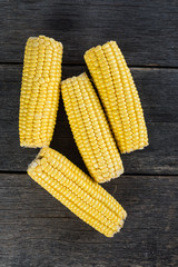 corn cob on wooden table from above