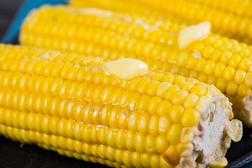 close view on Homemade golden corn cob with butter and salt