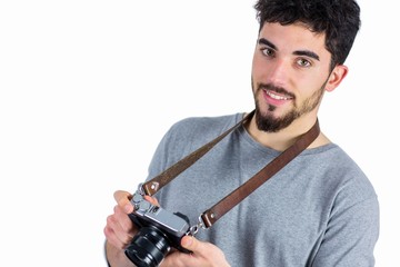 Casual man holding his camera