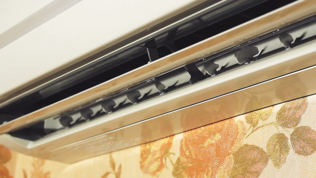 Switching on air conditioner, close up.