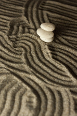 Fototapeta na wymiar three stones in the sand