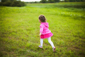 beautiful carefree girl playing outdoors in field
