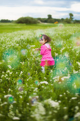 beautiful carefree girl playing outdoors in field