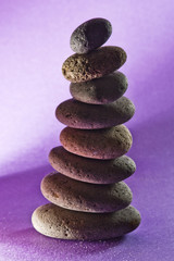 Fototapeta na wymiar eight stones in the sand,black-ground purple