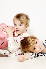 Brother and sister with piggy bank