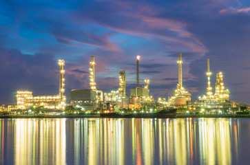 Oil refinery with reflection, petrochemical plant at sunrise