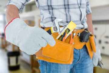technician using adjustable wrench against white background