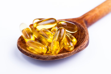 Fish oil on a spoon in white background.