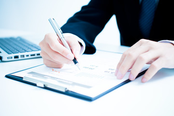 Businessman analyzing investment charts. Accounting