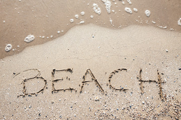 handwriting word beach at sea beach sand