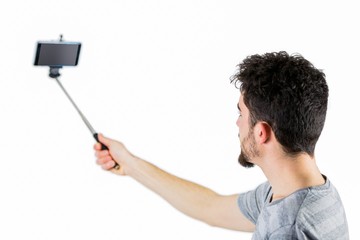 Casual man using a selfie stick