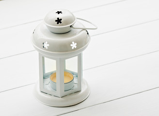 retro candle lantern lamp at white wood panel