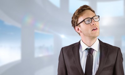 Obraz premium Composite image of young businessman thinking and looking up