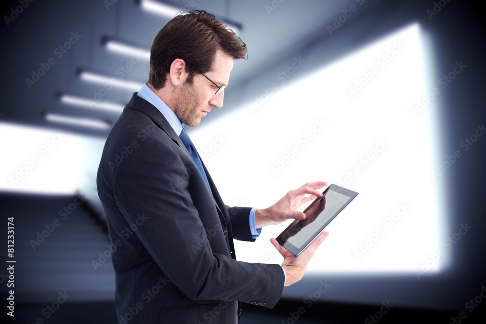 Poster Composite image of businessman standing while using a tablet pc