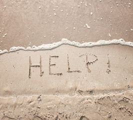 handwriting message word help at sea beach sand