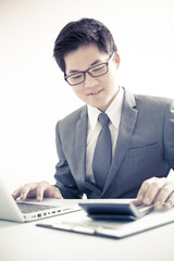 Handsome businessman working with laptop