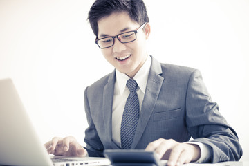 Handsome businessman working with laptop