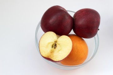 Apples and orange in vase