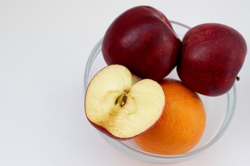 Apples and orange in vase