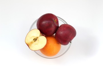 Apples and orange in vase
