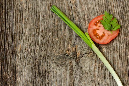 Sliced tomato with onion and leaf of parsley