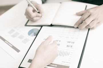 Two businessmen looking at report and having a discussion in off