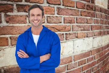 Happy mechanic with arms crossed