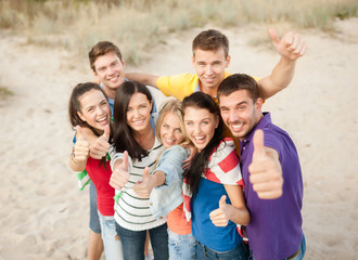 group of happy friends having fun on beach