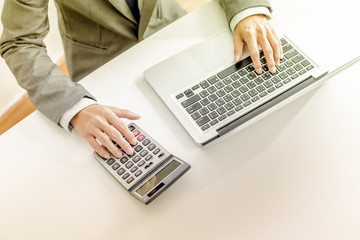 Closeup of businessman hands typing on laptop computer