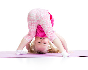 little girl standing on her hand isolated on white