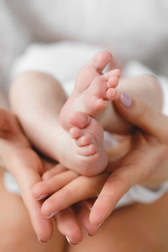 Baby's foot in mother hands.