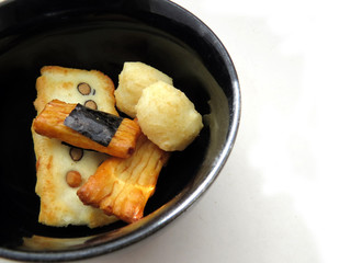 Japanese rice crackers in black bowl