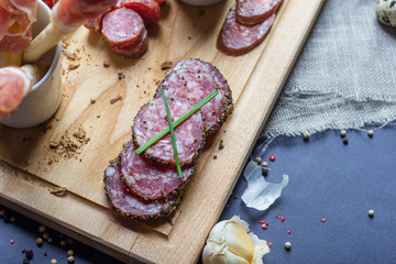 mix of traditional spanish ham, salami, parma ham on grissini