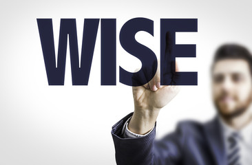 Business man pointing the text: Wise