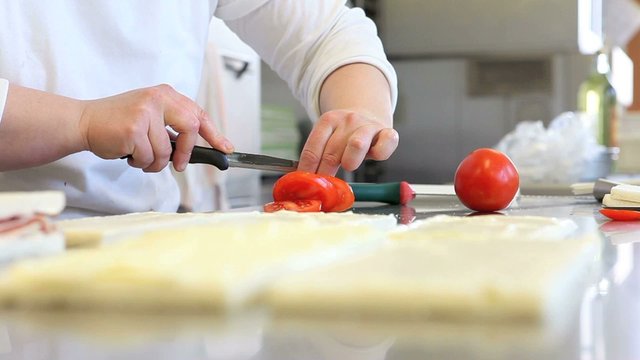 hands prepare sandwich with tomato mozzarella