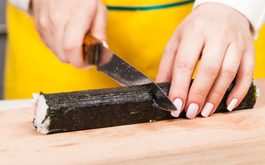 cook cuts the roll closeup