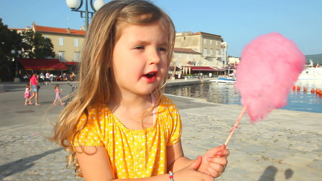 girl eating candy floss