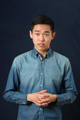Young Asian man looking at camera