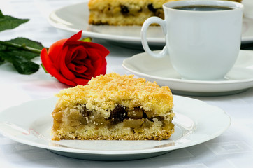 Apple pie with a cup of coffee and red rose